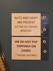 Disclaimer signs at ice cream window, Millie's Spring Valley restaurant, Washington, D.C.