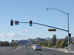 State Highway Junction Route CA-18 Westbound Happy Trails Highway approaches, proceeds and crosses at Kiowa Road intersection traffic signal green lights, left turn protected red yellow green arrow lights and pedestrian crosswalk crossing don't walk