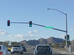 State Highway Junction Route CA-18 Westbound Happy Trails Highway approaches, proceeds and crosses at Flatheat Road intersection traffic signal green lights, left turn protected red yellow green arrow lights and pedestrian crosswalk crossing don't walk
