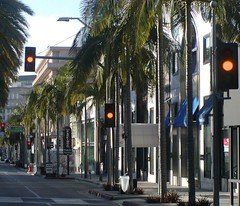 Southbound Rodeo Drive approaches, proceeds and crosses at 400 blocks of North Rodeo Drive Pedestrian Crosswalk Crossing mid-block traffic signal flashing yellow lights followed by No Left Turn but One Way Right Turn at Brighton Way intersection