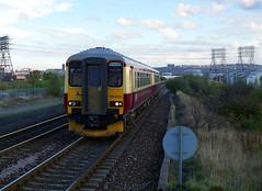 class 156s in Strathclyde carmine and cream in England