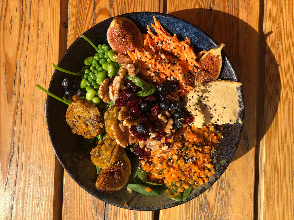Top view of vegan bowl with figs on wooden background at Good Food Bar & Restaurant, Cologne