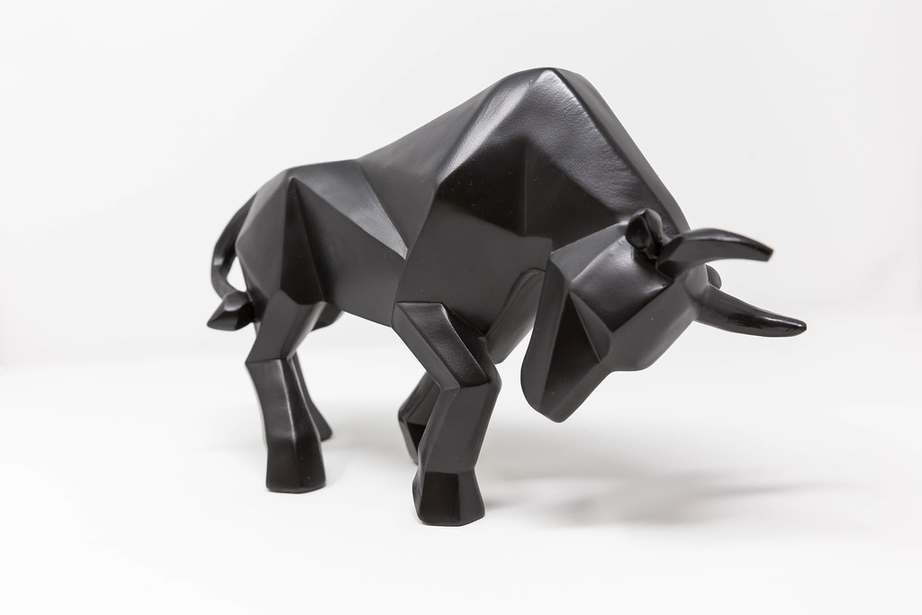 A black bull as a symbol for the stock bull market on a white background