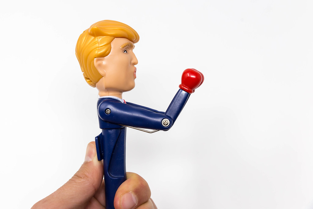 Hand holding the Trump stress relief pen with red boxing gloves talking in his real voice