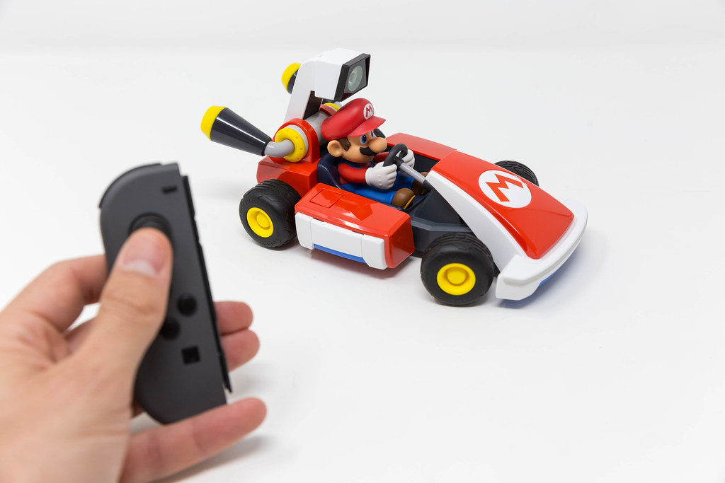 Male hand pushes a button on Nintendo Switch to get the race begin with the Mario Kart