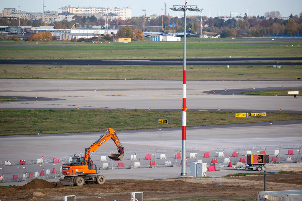 Endless construction works: a small excavator at the newly opened Berlin Brandenburg airport BER
