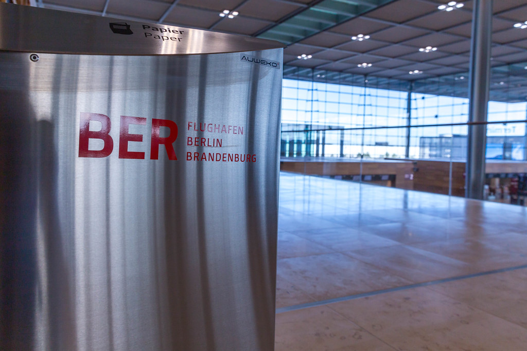 Separate waste collection: close-up of garbage bin with BER Airport Berlin Brandenburg logo in red