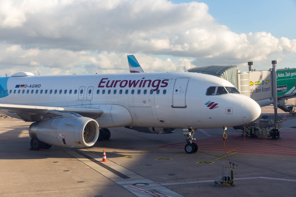 A Eurowings airplane with passenger boarding bridge at the apron of Cologne/Bonn Airport