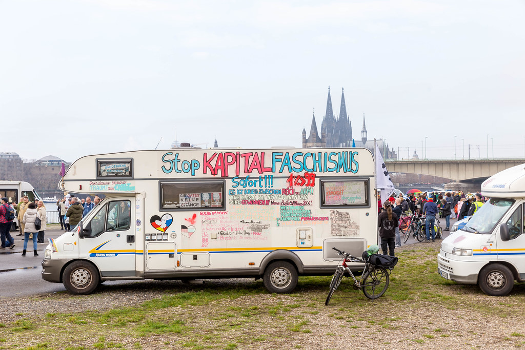Motorhome with antifascist slogans with the Cologne cathedral in the background at Covid protest