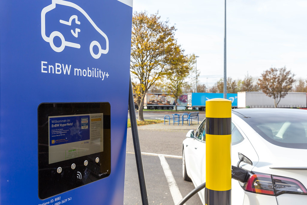 A Car is charging on a modern EnBW mobility+ Electric Vehicle Charging Station at a Rest Stop in Rhineland-Palatinate, Germany