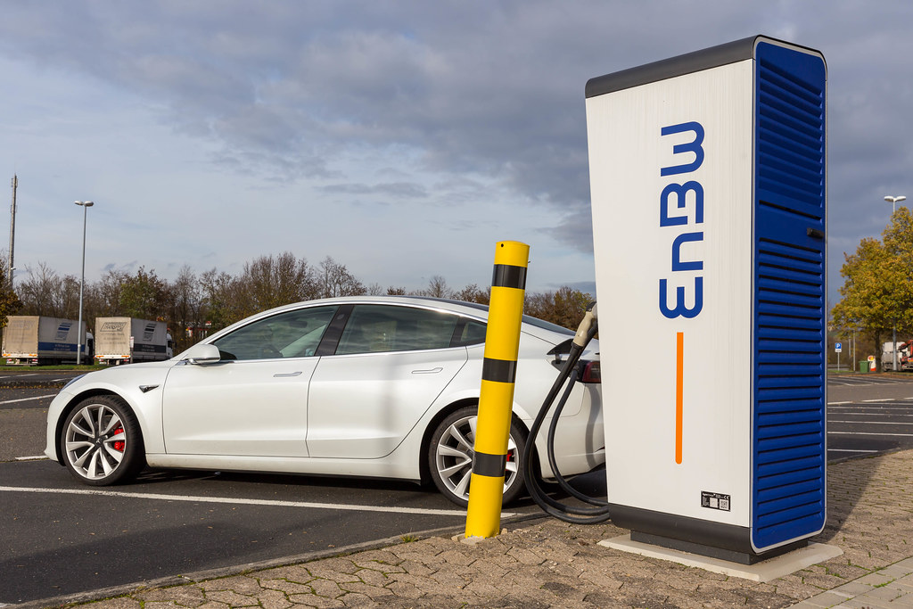 Electric Vehicle Tesla Model 3 is charging on a mobility+ Charging Station of EnBW at a Rest Stop in Germany