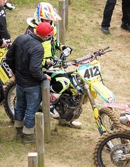 A father coaches junior, for a motocross race, in June 2015