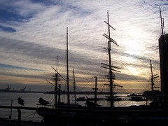 Sail ship, seabirds and sunset shadow pattern at South Street Seaport historic district, New York