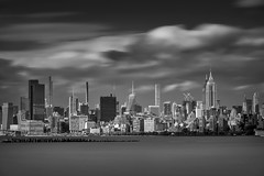 Long exposure of clouds over Midtown Manhattan and the Hudson River.