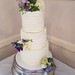 Three tiered buttercream wedding cake with fresh flowers