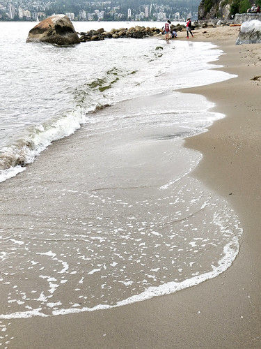 Waves hit sand at Third Beach