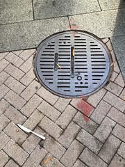 A knife in the road: sidewalk and manhole on Pennsylvania Avenue NW, Washington, D.C.