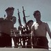 Vâlcov/județul Ismail, ROMÂNIA (anul 1943). În sudul Basarabiei, la vărsarea brațului Chilia al Dunării în mare. Soldați marinari ai Armatei Române la comanda mitralierei protejează un grup de ziariști aflați pe vapor de incursiuni ale aviației bolșevice.