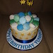 Macarons topped white chocolate ganache covered birthday cake