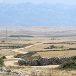 Winding road through rocky pastures