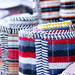 Colorful rugs and textile fabrics for sale at Dilli Haat New Delhi India, a market filled with colorful handicrafts and handmade items
