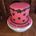 Red iced scroll themed birthday cake