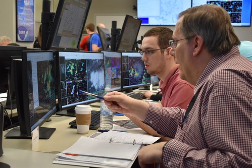 CIMMS Researcher Dale Morris works with an OU School of Meteorology student. Students partook in training normally provided to NOAA National Weather Service forecasters by the NWS Warning Decision Training Division, with support from CIMMS researchers, in March 2019 as part of their coursework. 