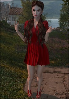 Pie wears braided hair, moon earrings, red sandals and a red dress.
