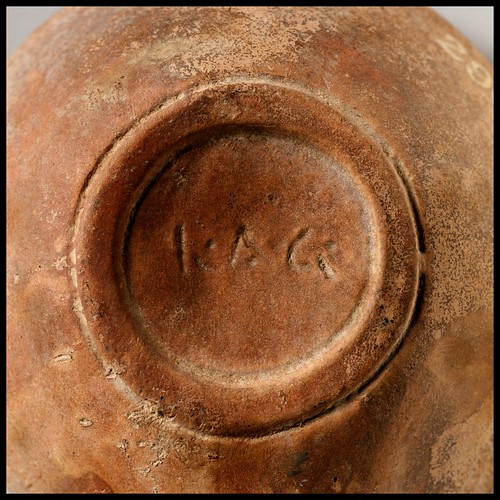 Roman terracotta lamp with discus bearing a human head in high relief