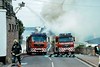 Two fire engines with fireman and smoke from burning building. This image is provided on an as-is basis, royalty free for personal editorial, blog and web display usage. - Royalty Free Trains, Planes & Automobilies