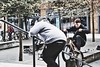 Man videoing boy doing bike tricks in London. This image is provided on an as-is basis, royalty free for personal editorial, blog and web display usage. - Royalty Free People & Candid Situations