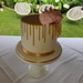 Single tiered wedding cake adorned with sugar flowers