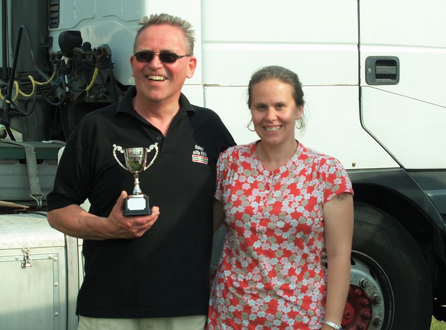 A happy Ray Foley receives his Class E winner's trophy at Cadwell