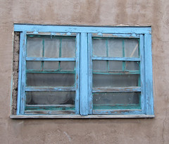Blue window on adobe wall