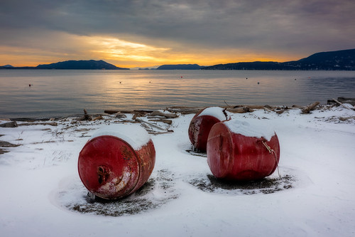 Fishing Buoys Covered With Snow at Sunset.