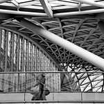 Woman walking along overhead walkway Kings Cross by Rich Goldthorpe