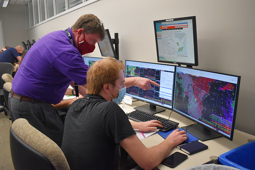Andy Wood, a research scientist team lead from CIWRO's Warning Decision Training Division working with NOAA's National Severe Storms Laboratory, instructs a meteorologist during the Radar and Applications Course (RAC) on April 18, 2022, at the National Weather Center in Norman, OK. The flagship course allows forecasters to practice issuing severe storm warnings in a simulated environment.