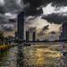 Early evening view of the Chao Phraya river, pier and adjacent tall buildings, Bangkok, Thailand.  793-Edita
