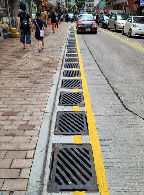 雨水渠 Stormwater drains．筲箕灣東大街一段約30米道路，裝設逾40個雨水渠口，形成密集的“水渠陣”，目的是在暴雨期間加快收集及排走雨水，防止水浸