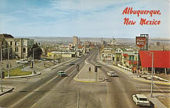 Albuquerque, NM - vintage postcard of Central Ave (U.S. 66) looking west at the downtown skyline - circa early 1960's