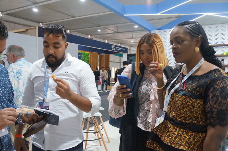 Visitors at WorldFish&#039;s aquatic foods exhibition at the 27th United Nations Climate Change Conference (COP27). Photo by Aniss Khalid, WorldFish.