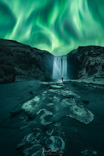 Northern lights dance over Skógafoss, the treasure waterfall – Skógar (Iceland)
