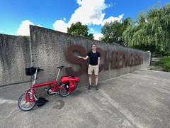 Jon Worth and bike at Schengen sign at Schengen