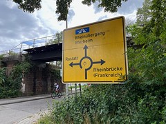 Rail bridge and road sign - to the border and France - Photo of Eberbach-Seltz