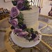 Two tiered buttercream engagement cake with a cascade of fresh flowers