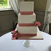 Three tiered square wedding cake with sugar roses