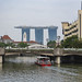 Coleman Bridge across the Singapore river with tourist boat and Marina Bay Sands Hotel