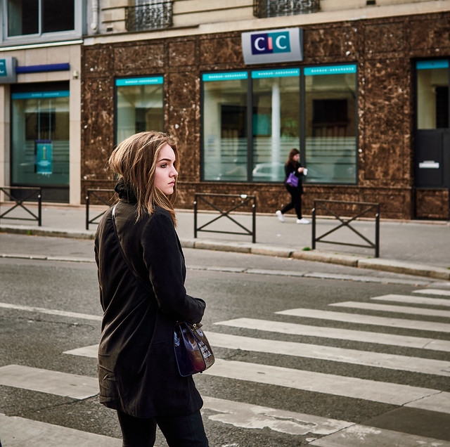 Young woman crossing the street - Paris, France