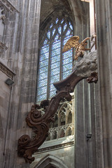 Stained glass and one of the supports of the crucifix