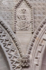 Stonework details in the nave: virgin and child, and an Asian wizad